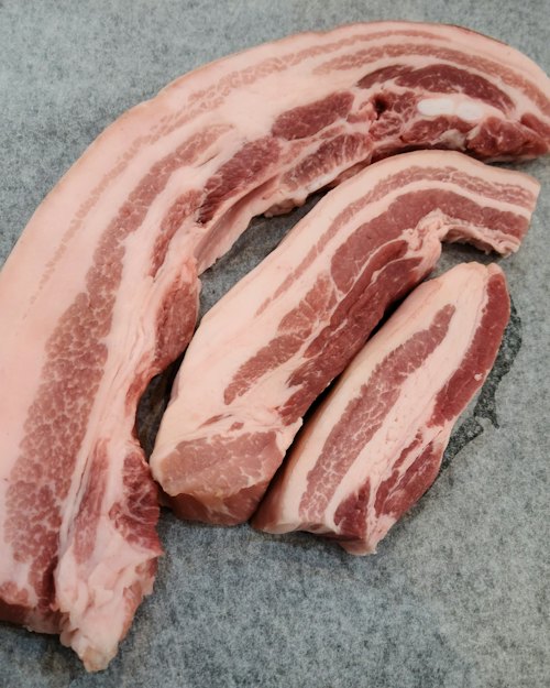 Strips of raw pork belly